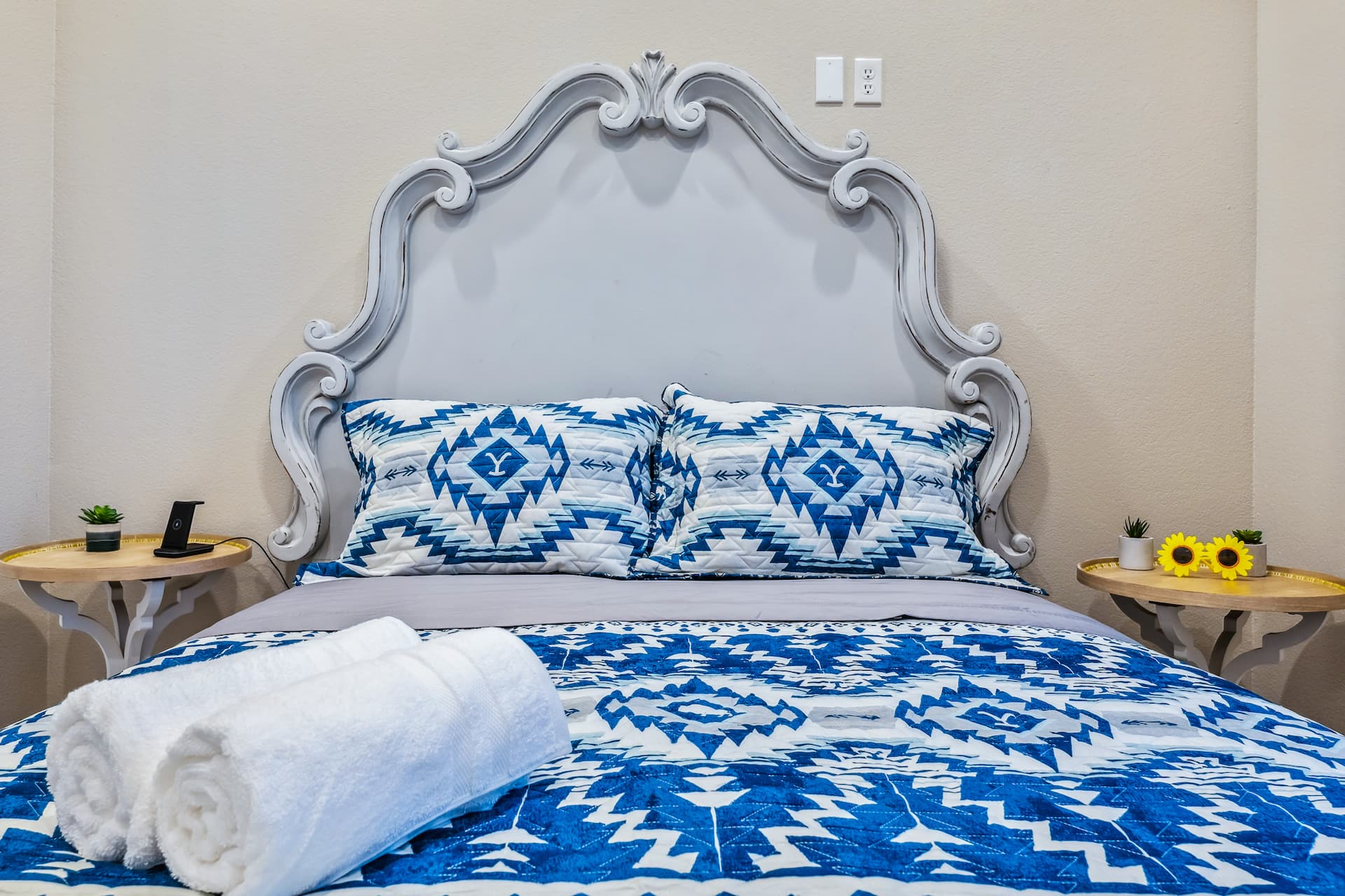 Queen bedroom with ornate headboard